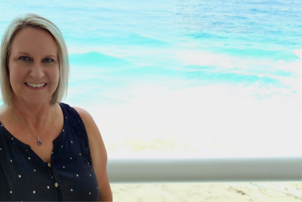 Diana Bertrand overlooking the beach and Caribbean Sea in Cancun, Mexico.