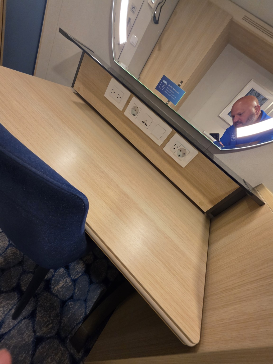 Desk, illuminated mirror, outlets, and USB charging area in our Wonder of the Seas balcony cabin.