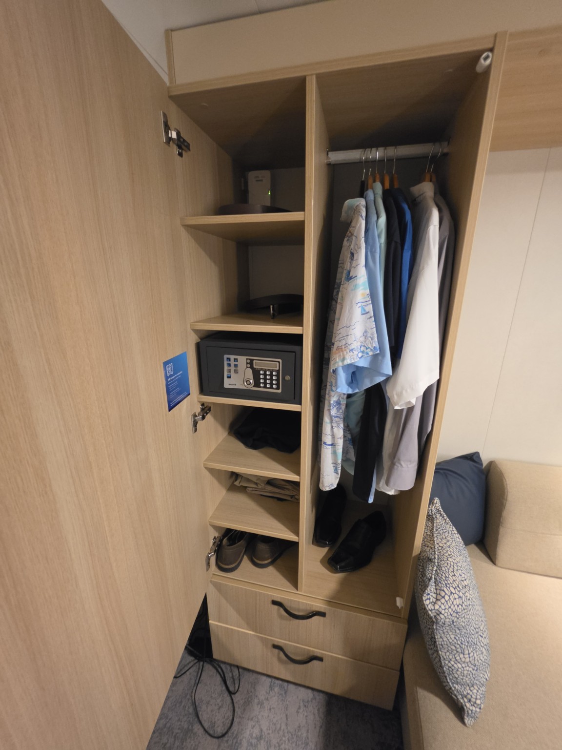 Closet shelving, safe, hanging space, and drawers in our Wonder of the Seas balcony cabin.