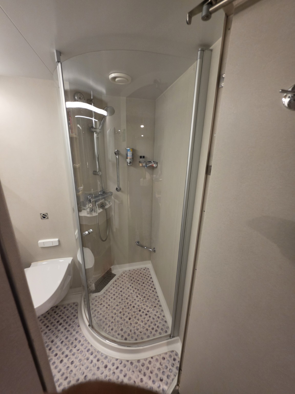 Curved glass shower in our Wonder of the Seas balcony cabin.